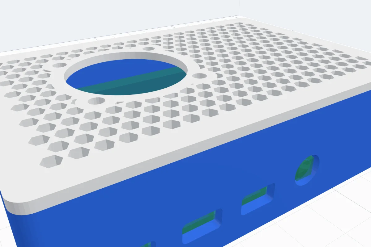 A blue Raspberry Pi 4 case with a white honeycomb lid and a 30 mm fan opening, its ports cut out of the side
