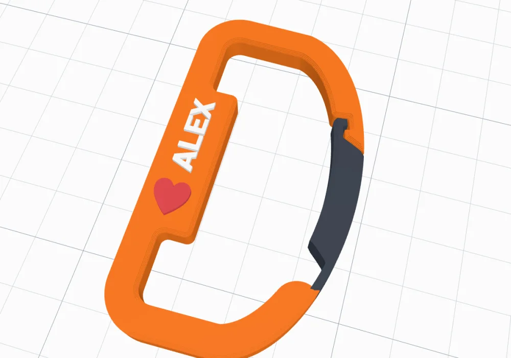 A carabiner with ALEX and a red heart on its spine