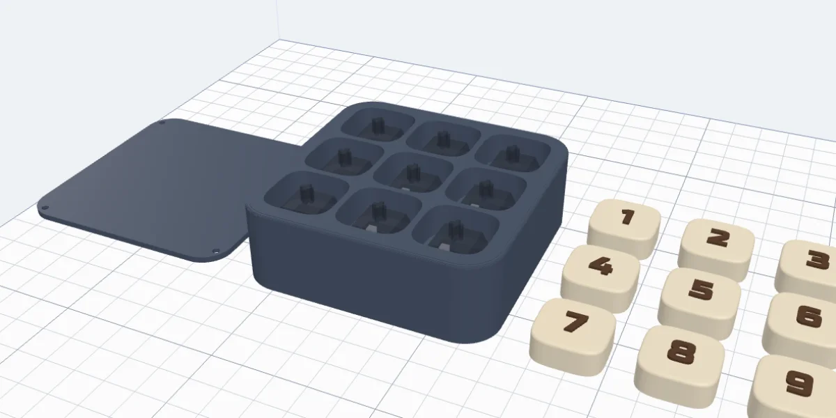 A nine-key pad laid out for printing: the bottom panel, the base and the caps