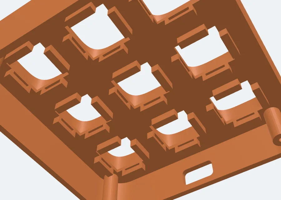 An open-bottom base seen from below: the switch holes with side locks, the screw posts and the cable slot