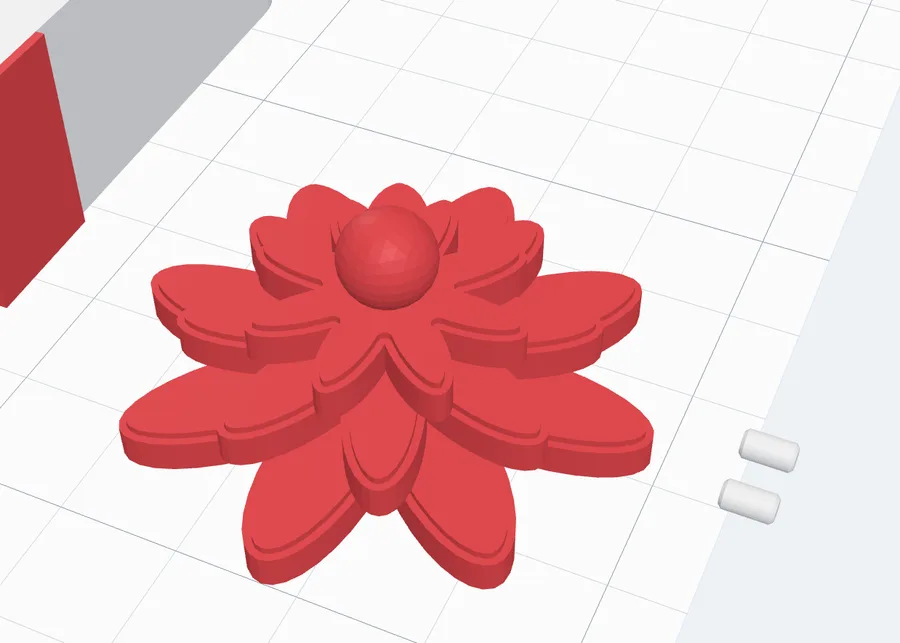 The bow and its two pins lying on the bed for printing