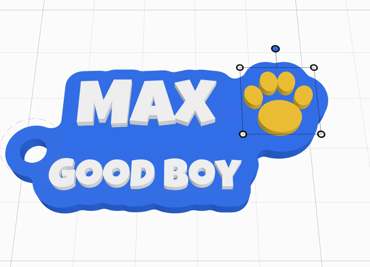 Arranging a keychain in the 3D view: the paw icon selected with corner handles and a rotate handle