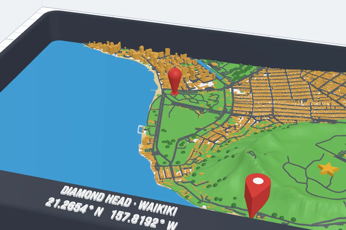 A 3D printed map of Waikiki and Diamond Head in Hawaii in a dark frame with the title DIAMOND HEAD · WAIKIKI and its coordinates, red map pins and a yellow star