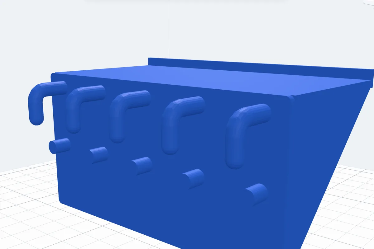 A shelf for a quarter inch pegboard seen from behind: J-hooks bend down behind the board's round holes