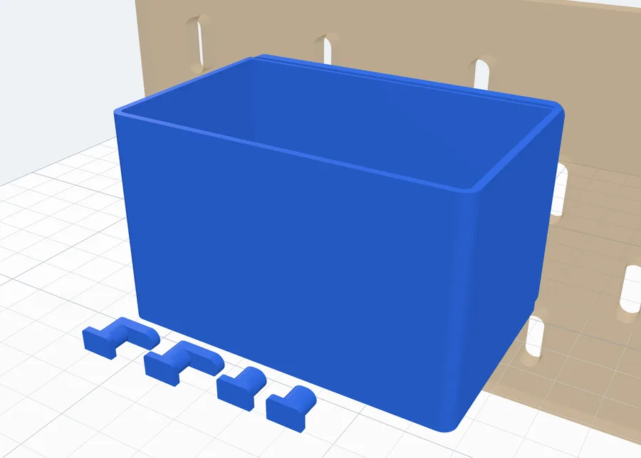 A box with its four peg clips lying flat beside it