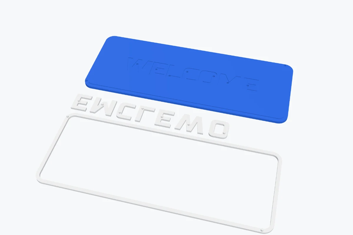 The plate in separate pieces laid out for printing: the plate with pockets and the letters and border face down below it