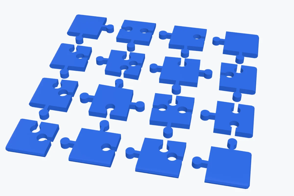 A 3D printed jigsaw puzzle with custom lollipop-shaped knobs, the pieces spread out