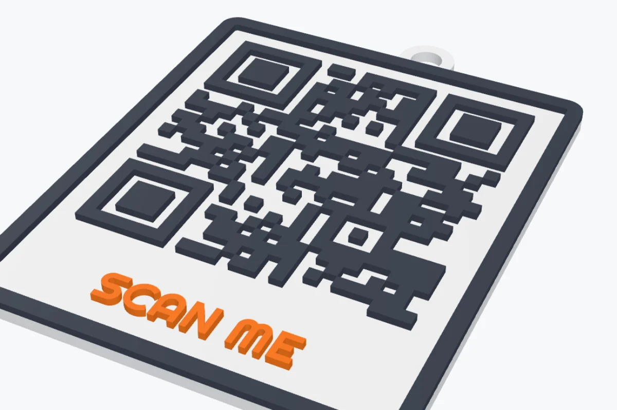 A 3D printed QR code plate with a dark frame, the orange label SCAN ME and a key ring