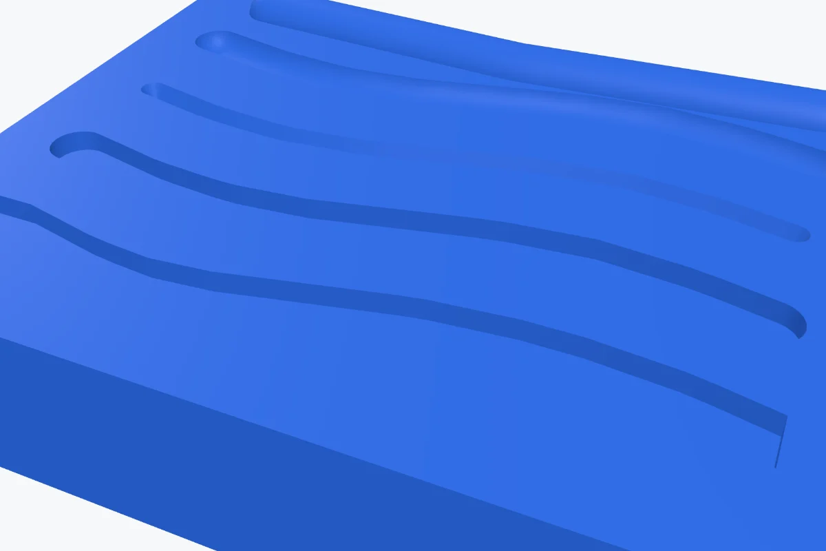 A blue plate with grooves carved by the sphere, cone, cylinder and box brushes and a ridge built up with Add