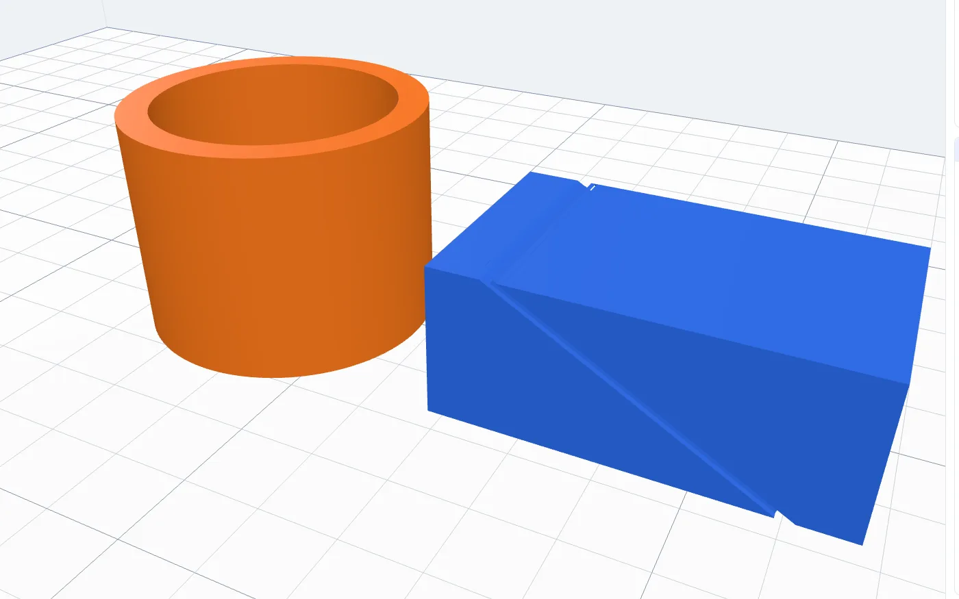 The finished tube beside the box with a round groove leaning at 30 degrees all the way round it