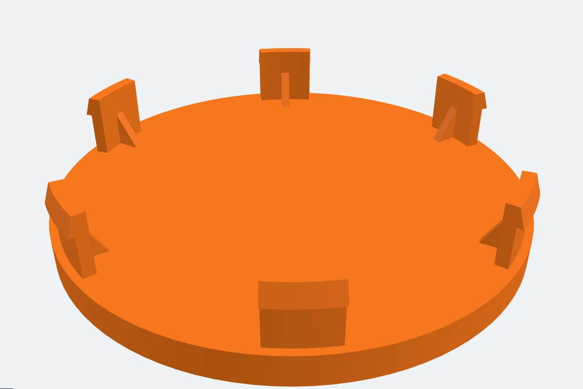 An orange wheel centre cap with six curved barbed snap legs standing on its back face