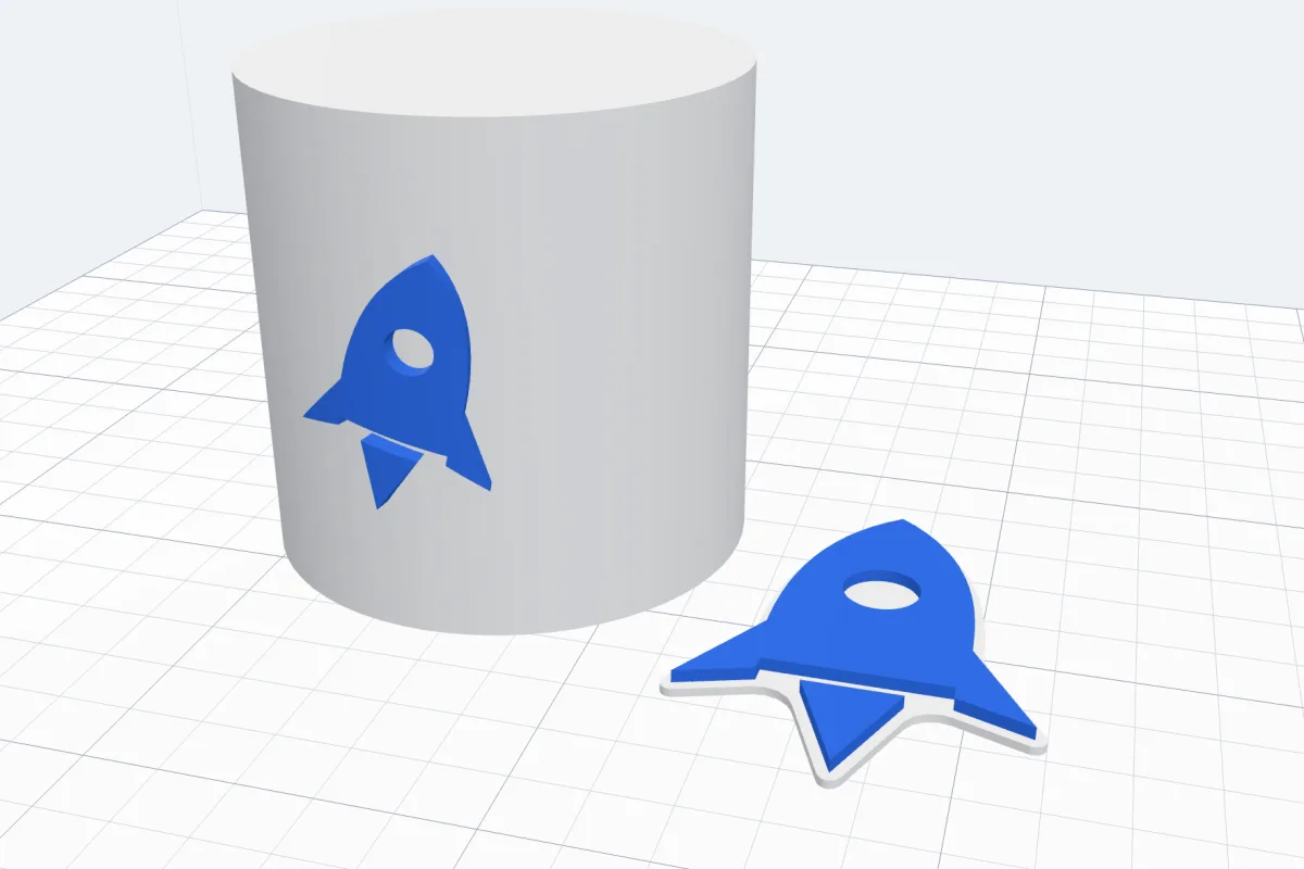 A blue rocket SVG on a white joined base lying on the bed, and the same rocket raised on the side of a white cup