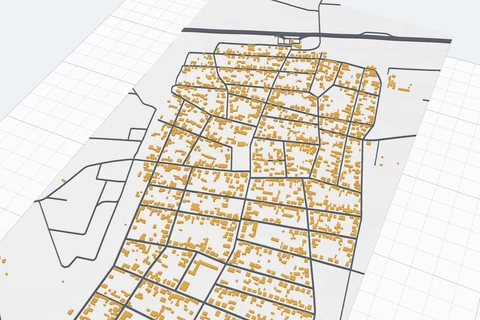 A 3D printed map of a village: yellow buildings and grey roads on a white base